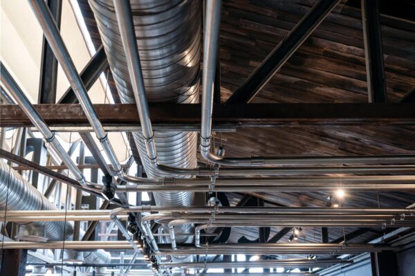 ceiling-structure-with-steel-ventilation-pipe-and-shiny-pipe-systems-min